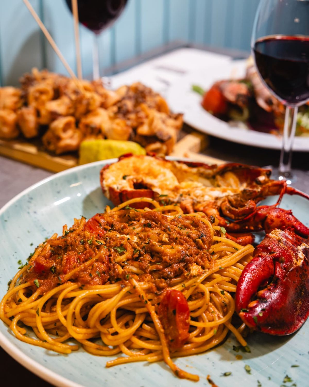 Lobster spaghetti served with red wine
